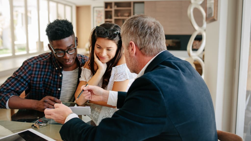 Customers and real estate agent talking before buying a home