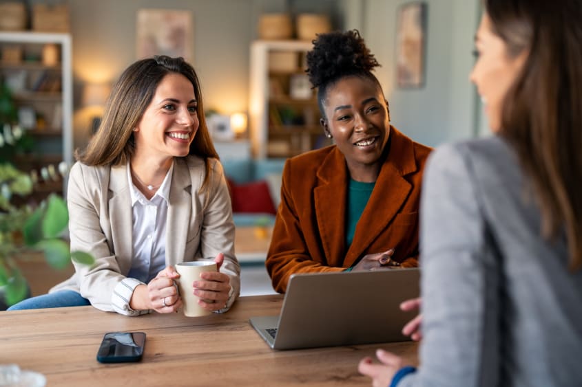Real estate broker meets with two clients